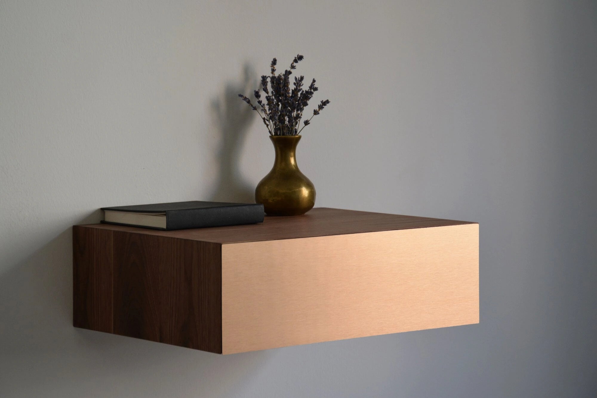 floating bedside cabinet with copper drawer