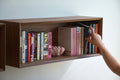 wall-mounted bookshelf made of walnut