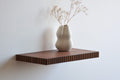 walnut floating shelf with fluted edge