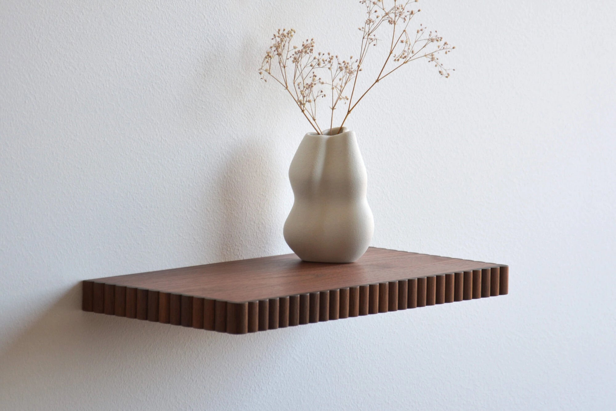 walnut floating shelf with fluted edge
