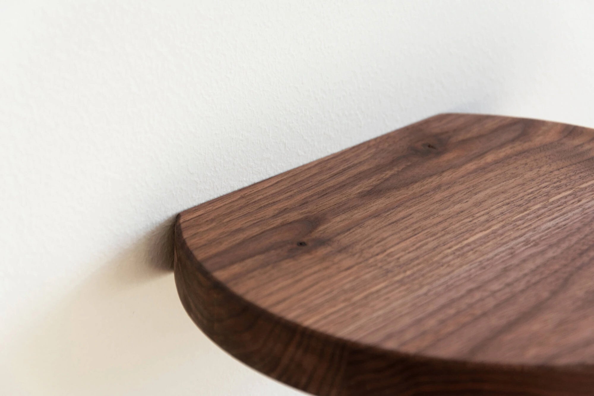 walnut floating shelf with curved shape