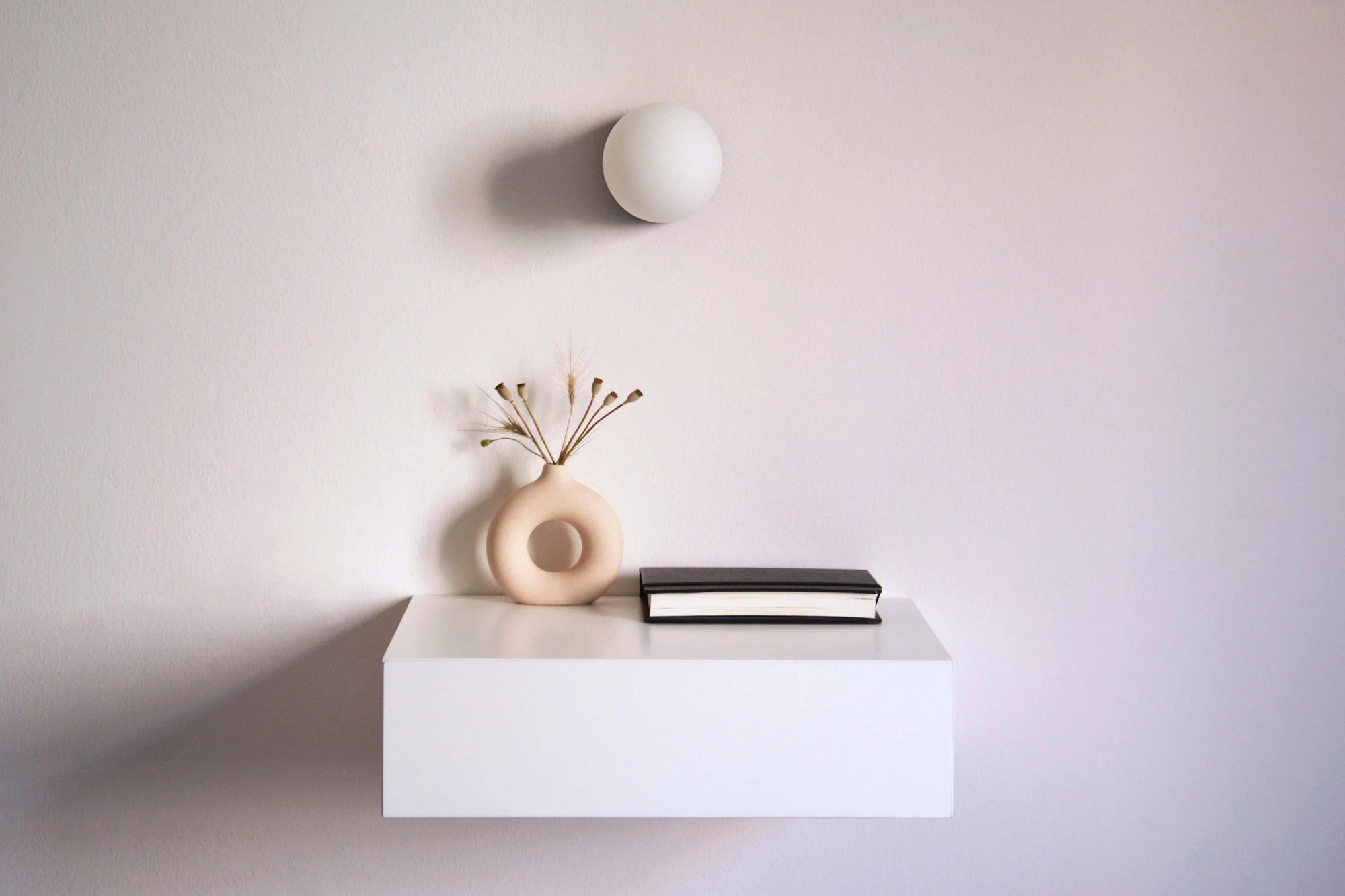 white floating bedside table