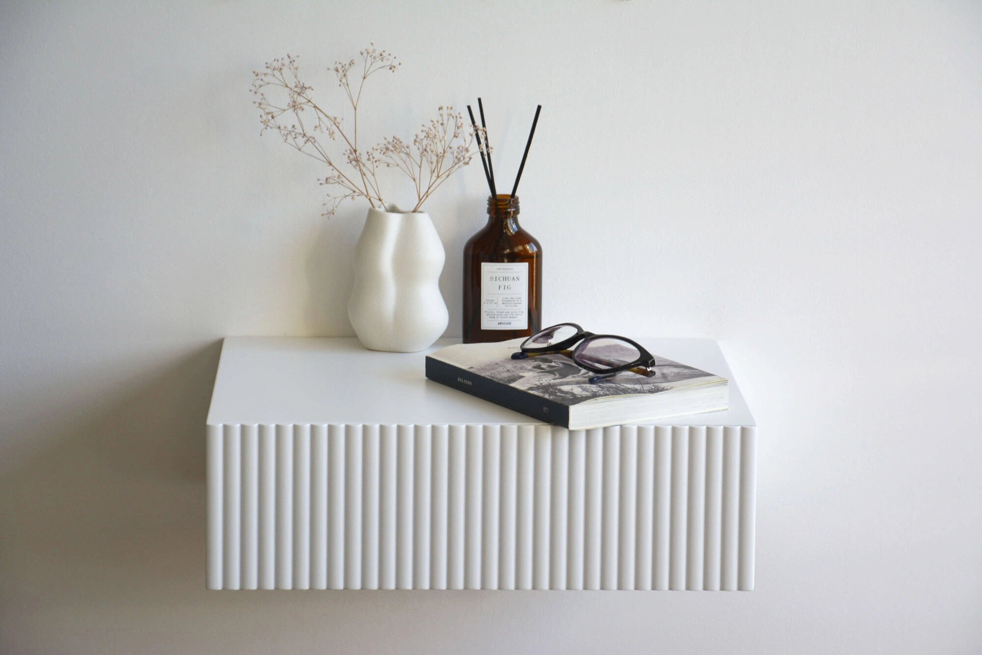 white nightstand with fluted drawer